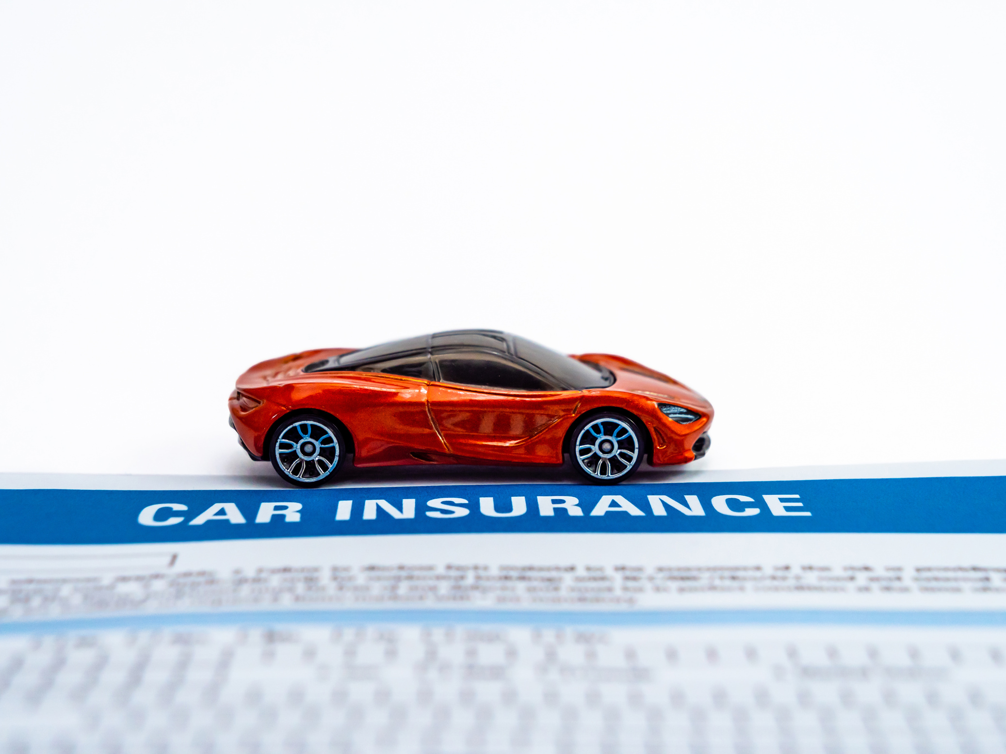Toy Sports Car and Car Insurance Document